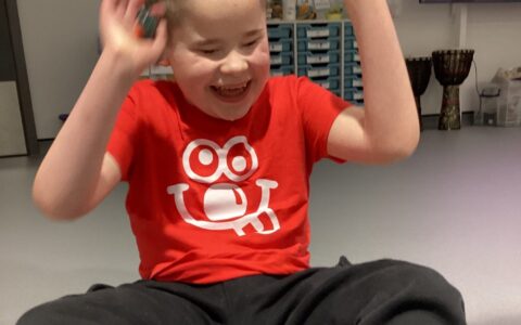 Boy in red tshirt laughing